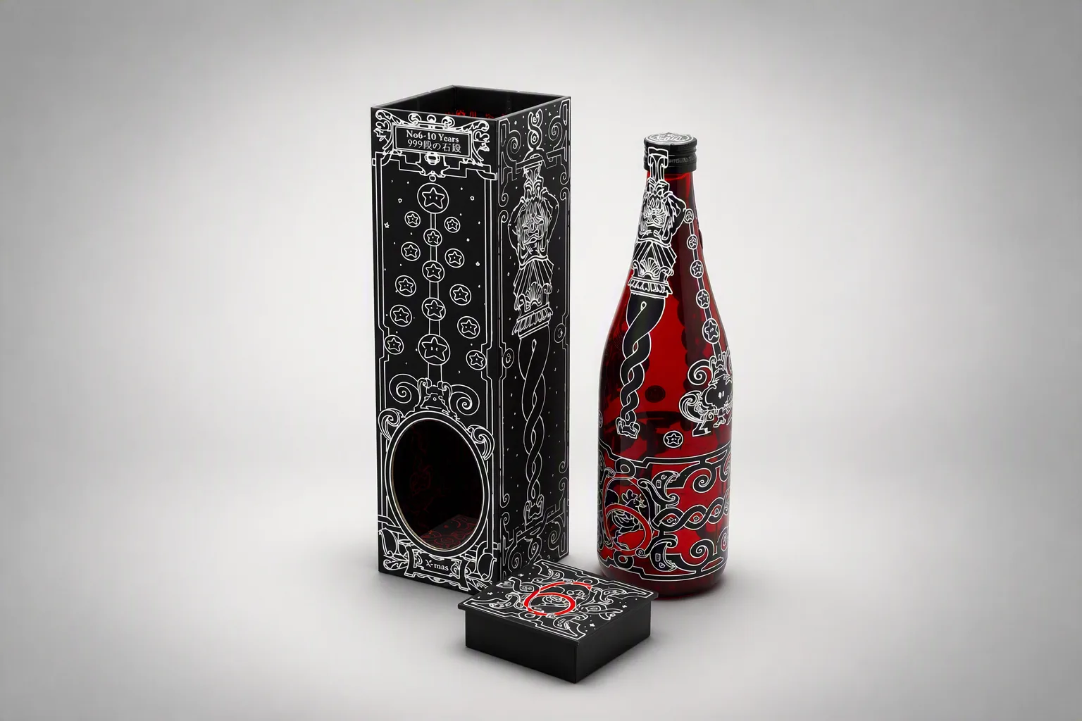 クリスマス限定 日本酒ギフトボックス。楕円の窓抜きから黒チップボードの断面が見える高級パッケージで、内箱の内側にも柄を印刷